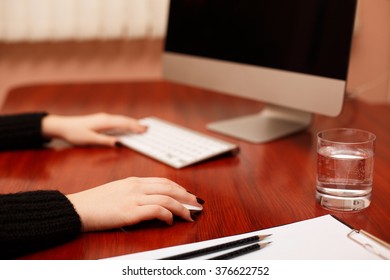 work in office at computer. mockup work on PC. Side view of the computer is on the work table in a Home office. freelancer woman working with computer