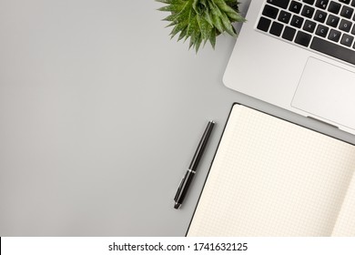 Work office desk table with laptop, notepad,and home plant. Top view with copy space, flat lay finance background