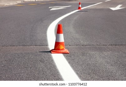 Work On Road. Construction Cones. Traffic Cone, With White And Orange Stripes On Asphalt. Street And Traffic Signs For Signaling. Road Maintenance, Under Construction Sign And Traffic Cones On Road.