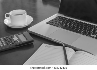work on a wooden desk with a laptop and nootbook and calculator monochrome
 - Shutterstock ID 432742405