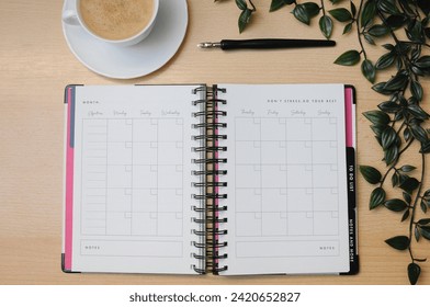 A work organizing diary on a flat surface with coffee 