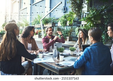 Work outside the box. Shot of a group of designers having a meeting at a coffee shop. - Shutterstock ID 2151107163