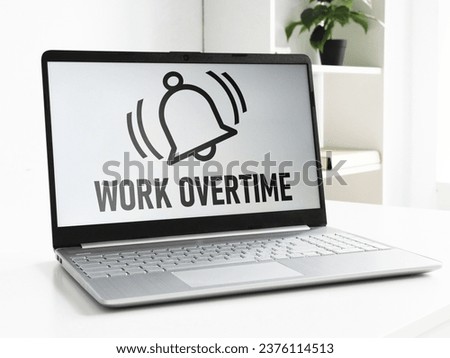 Work Overtime is shown using a text on the laptop and picture of the bell of alarm clock