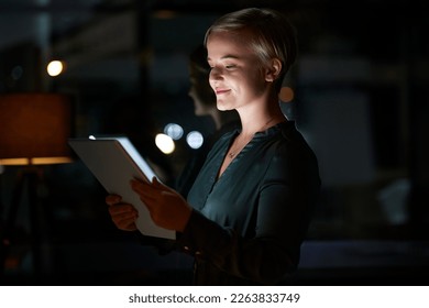 Work, overtime and woman with tablet, smile and internet search, working late on digital design project. Dark night at office, designer at in creative startup reading online market research report. - Powered by Shutterstock