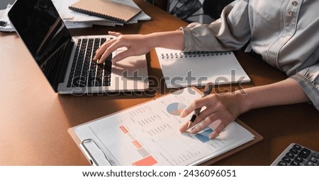 Work performance summary report Asian woman working online and planning financial information with laptop working from home Businesswoman and planner concept