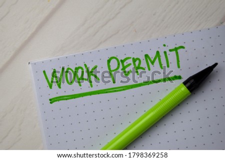 Work Permit write on a book isolated on office desk.