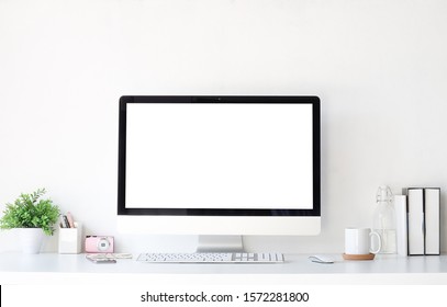 Work place concept Mockup blank screen  Office desk Workspace stuff with notepad, laptop and coffee cup mouse notepad shot. - Powered by Shutterstock