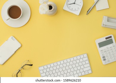 Work Place With Keyboard, Glasses, Coffee, Phone, Calculator, Flowers On Orange Background. Flatlay, Top View. 