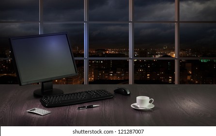 Work Place In The Office At Night With A City View From Window