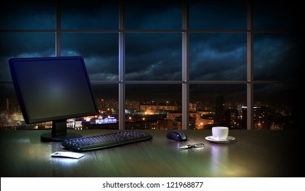 Work Place In The Office At Night With A City View From Window