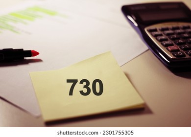 Work place with a post it note with the text "730” concept of declaration model for tax payment .