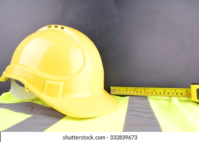 Work Place Safety Concept With Safety Equipment And A Blackboard In The Background