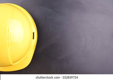 Work Place Safety Concept With Safety Equipment And A Blackboard In The Background