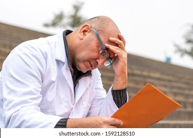 Work Problem. Desperate, Scared, Disappointed Medical Worker Facepalming Reading Bad News On Paperworks