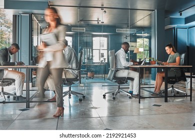 Work Process Of Busy Corporate Team Of Business People Working At Startup Marketing Company, Planning Email On Laptop And Sitting At Desk In Office. Blur Of Employees, Workers And Businesspeople