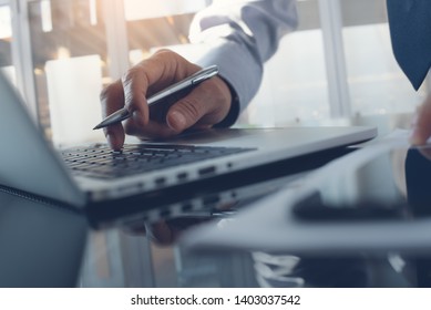 Work Process Concept. Business Man Typing On Laptop Computer Keyboard With Paperwork And Mobile Smart Phone On Desk In Modern Office With Blurry Background, Close Up.