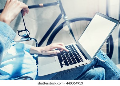Work process modern design Studio Loft.Creative manager working coworker office new freelance business startup.Using Laptop knees,holding glasses hand.Reflection.Horizontal mockup.Film effect.Closeup