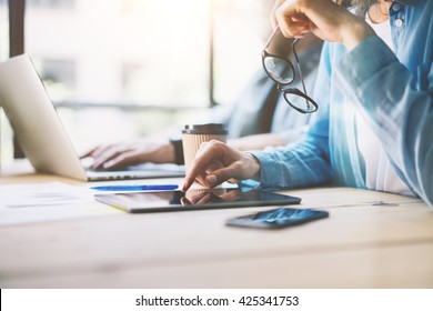 Work Process Modern Studio Loft.Artdirector Woman Working Wood Table With New Freelance Business Startup. Using Digital Tablet,Touching Screen. Horizontal.Film Effect. Blurred Background.