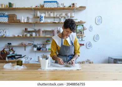 Work process in pottery studio: creative artist girl modeling sculpture from raw clay for potter handicraft. Professional craftswoman prepare ceramics for sale in retail store. Entrepreneur concept