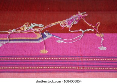 Work in process of Thai silk weaving with traditional hand weaving loom.