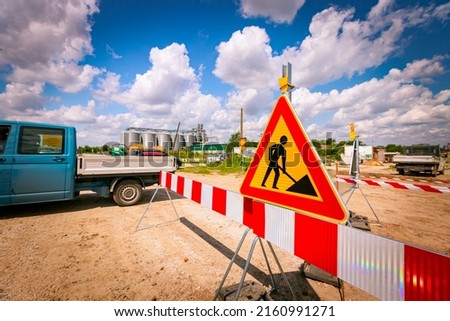 Work in progress, triangle sign with boundary, caution symbol on construction site. 