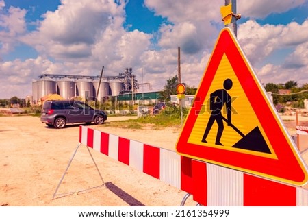 Work in progress, triangle sign with boundary, caution symbol on construction site. 