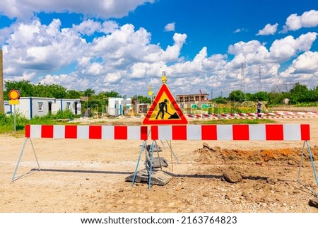 Work in progress, triangle sign with boundary, caution symbol, trench is on construction site. 