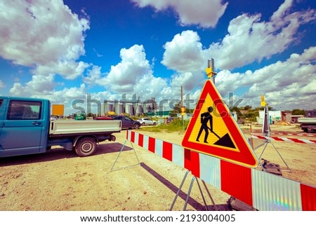 Work in progress, triangle sign with boundary, caution symbol on construction site. 