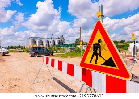 Work in progress, triangle sign with boundary, caution symbol on construction site. 