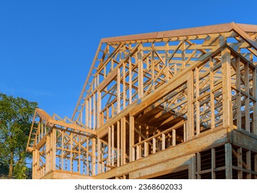 Work in progress view of unfinished house construction with wooden framing beams