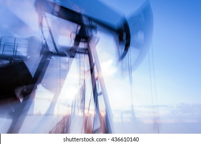 Work Of Pump Jack On A Oilfield. Double Long Exposure, Blurred Motion.  Concept Oil And Gas Industry.