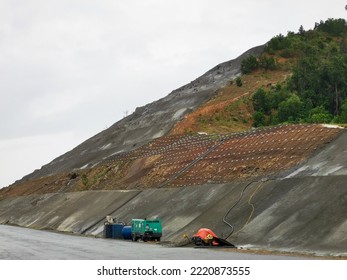 Work of reinforcing the hill slope by the road side with concrete and metal mesh reinforcement to prevent land slide. - Shutterstock ID 2220873555