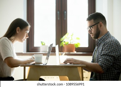 Work Rivals Feeling Jealousy, Envy, Looking At Each Other Behind Laptops, Competing In Developing Business Strategy, Staring Defiantly With Hate And Distrust. Concept Of Gender Equality, Competition