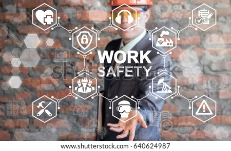 Work Safety Concept - regulations and standard in industry, business. First secure rules. Health protection, personal security people on job. Man in helmet offers work safety icon on virtual screen.