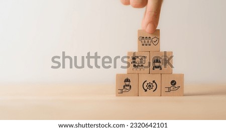 Work safety concept. Wooden cube blocks with icon of safety at workplace surrounded by safety first, protections, health, regulations and compliance. Working standard process. Zero accidents.