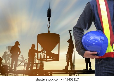 Work Safety Officer Or Civil Engineer. Silhouette Team Worker On Background Of Construction Site During Sunset Time