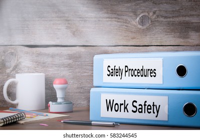 Work Safety And Safety Procedures. Two Binders On Desk In The Office. Business Background
