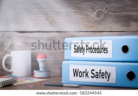Work Safety and Safety Procedures. Two binders on desk in the office. Business background