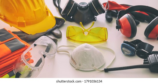 Work safety protection equipment flat lay. Industrial protective gear on white background, closeup view. Construction site health and safety concept