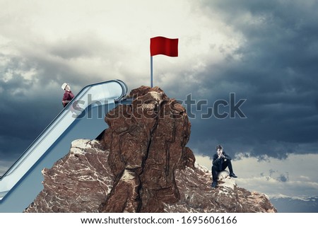 Work smarer not harder concept . Red flag on top of a mountain peak . Choose the right path . 