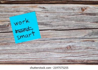 Work Smart Not Hard Concept. Sticky Note Reminder On Wooden Background.