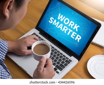 WORK SMARTER Businessman At Work. Close-up Top View Of Man Working On Laptop While Sitting At The Wooden Desk , Coffee