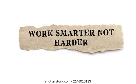 WORK SMARTER NOT HARDER - text on torn paper on white desk in sunlight.