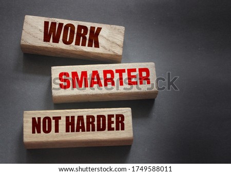 Work Smarter not harder words phrase on Wooden blocks business concept. self motivation concept.
