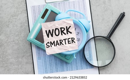 work smarter text on a pink card on the background of reports on the gray table.
