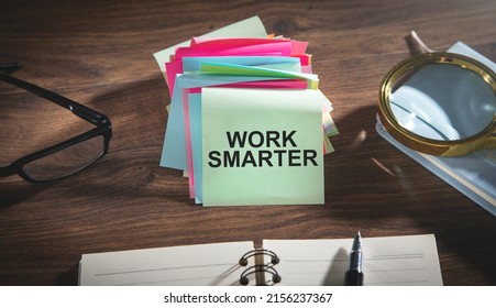 Work Smarter text on sticky notes with a business objects.