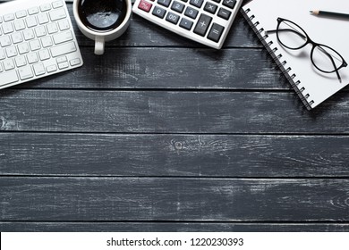 Work Space With Calculator, Keyboard And Glasses For Financial Report. Desktop Modern Business Person. Accounting Concept. Dark Background.