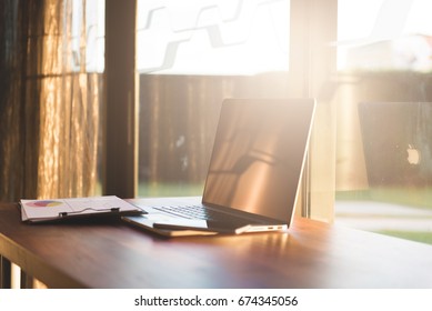 work space with computer laptop and chart on table