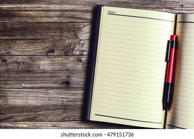 Work space desk with open notebook and pen