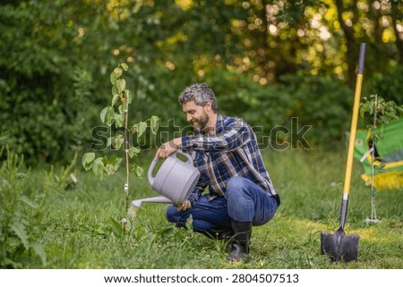 Work in spring yard with garden tool. Planting and growing plant. Spring farming, springtime. Planting tree. Gardening and farming. Hispanic farmer with shovel. Taking care of nature.